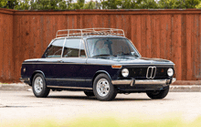 a black car with a roof rack and the number 00 on the front