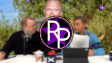 a group of people sitting at a table with a purple rp logo