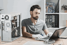 a man is working on a laptop with intel written on the back of the laptop