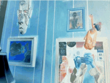 a blue wall with paintings and a sign that says hey sin