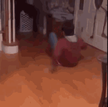 a man is sitting on the floor in a living room and dancing .