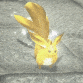 a yellow rabbit is sitting on a tile floor .