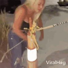 a woman is standing next to a pole with the word viralhog on the bottom