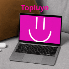 a laptop with a smiley face on the screen and the word topluyo on the top