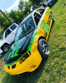 a yellow and green race car with the number 8 on the side