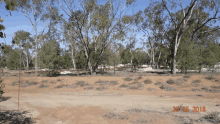 a photo taken on 29 05 2018 shows a dirt road with trees in the background