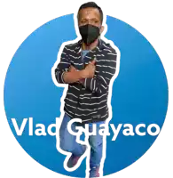 a man wearing a mask is standing in front of a blue circle with vlad guayaco written on it