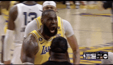 a basketball player wearing a lakers jersey is screaming