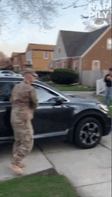 a man in a military uniform is getting out of a car with the words " had pily " above him