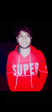 a young man wearing a red super sweatshirt