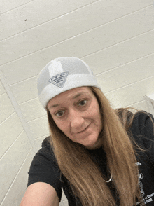 a woman wearing a white hat and a black shirt that says ' united states of america '