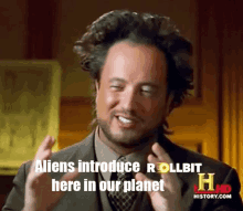 a man says " aliens introduce rollbit here in our planet " while wearing a suit and tie