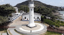 an aerial view of a lighthouse sitting on top of a circular concrete platform .