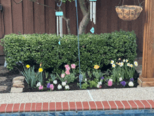 a garden with flowers and a wind chime that says ' i love you '