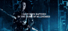 a woman holding a sword with the words " i have been baptized in the tears of my enemies " below her