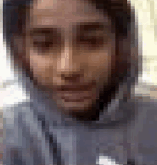 a pixelated image of a man 's face with a hood on