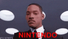 a man in a suit and tie says nintendo in red letters