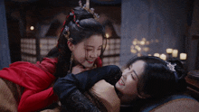 two asian women are hugging each other and smiling