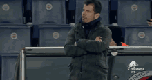 a man sitting in a stadium with a gif that says fenerbahce gifs