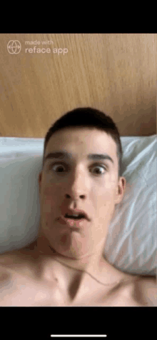 a shirtless man is laying on a bed and making a funny face