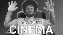 a man sitting in a chair with his hands in the air and the words absolute cinema behind him