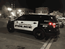 a marion police vehicle is parked in a parking lot at night