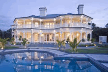 a very large house with a swimming pool in front of it .