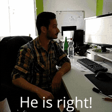 a man in a plaid shirt sits at a desk in front of a computer with the words " he is right " below him