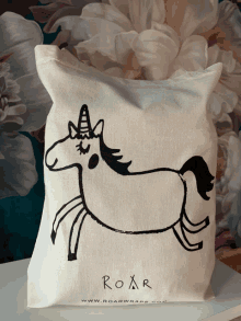 a tote bag with a picture of a unicorn and the word roar on it