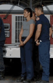 a group of firefighters are standing in front of a fire truck with a sticker on the side that says chicago fire department