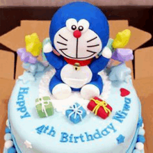 a birthday cake with doraemon and gifts on it