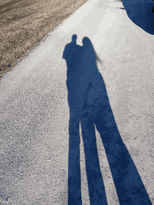 a shadow of a man and a woman standing next to each other