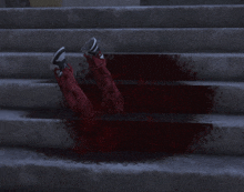 a person laying on a set of stairs with their feet in the blood