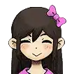 a girl with long hair and a pink bow in her hair is smiling .