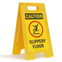 a yellow sign says caution slippery floor