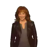 a woman with red hair is wearing a black leather jacket and a grey shirt