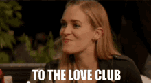 a woman says " to the love club " in front of her