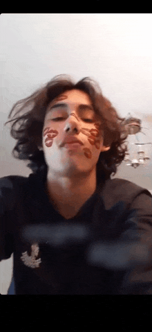 a young man with a tattoo on his face that says ' i love you '