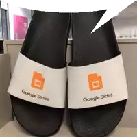 a pair of google slides sandals are sitting on a desk