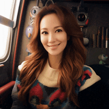 a woman with long red hair wearing a sweater smiles for the camera