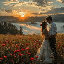 a man and a woman are standing in a field of flowers at sunset