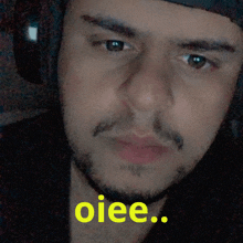 a close up of a man 's face with the words " oiee " on the bottom