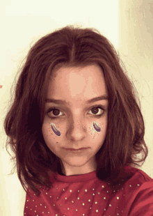 a girl with purple aubergine face paint on her face