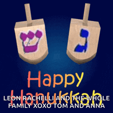 a happy hanukkah card with two wooden dreidels