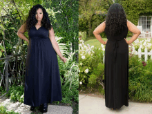 a woman in a black dress is standing in front of a white picket fence