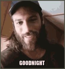 a man with long hair and a beard is wearing a baseball cap and says goodnight