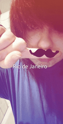 a person with a fake mustache in their mouth and the words rio de janeiro on the bottom right