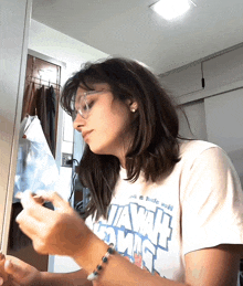 a woman wearing a white t-shirt that says ' hawaii comics ' on it