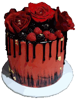 a red cake with raspberries and blackberries on top