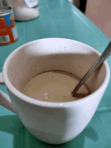 a cup of coffee with a spoon in it